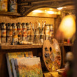 Close-up of the paint shelf with tubes, brushes and palette in The Artist's Studio