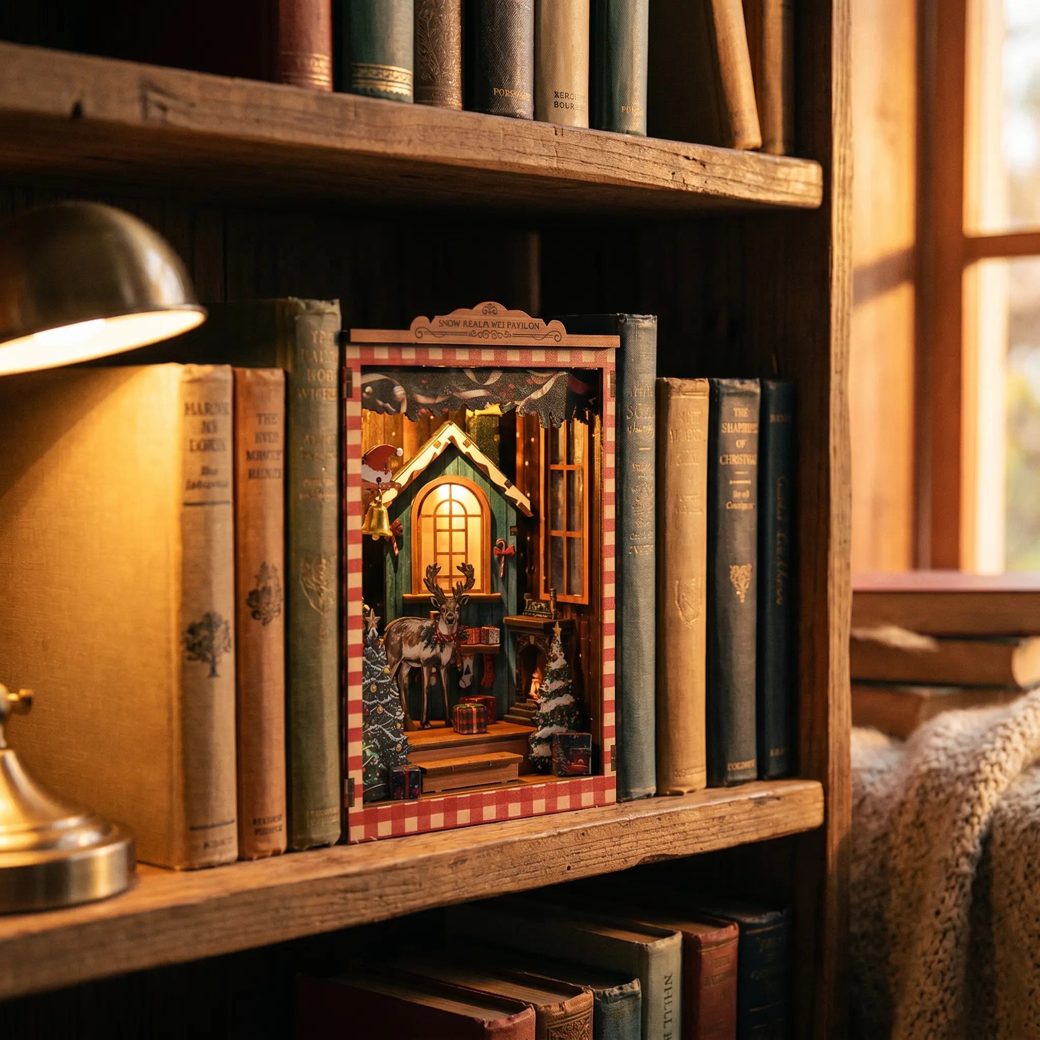 The Snow Cabin book nook slotted on a bookshelf between books at dusk
