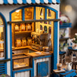 Close-up of the lit coffee counter inside The Santorini Café miniature