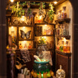 Close up of the lit interior of The Potion Workshop with cauldron and potion bottles