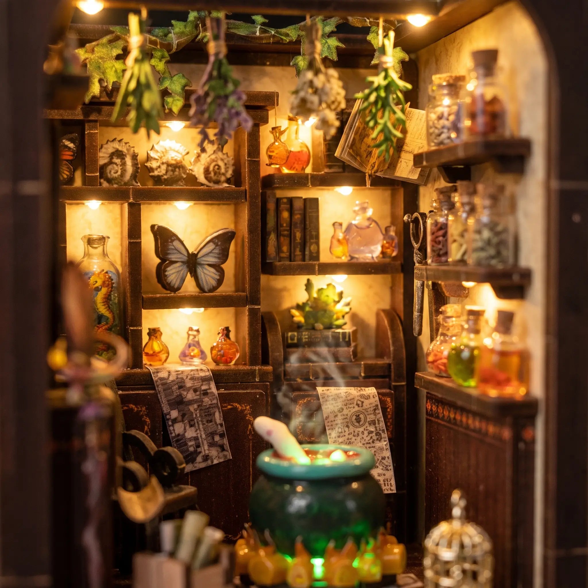 Close up of the lit interior of The Potion Workshop with cauldron and potion bottles