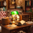 Close-up of the brass banker's lamp on the writing desk inside The Left Bank Study