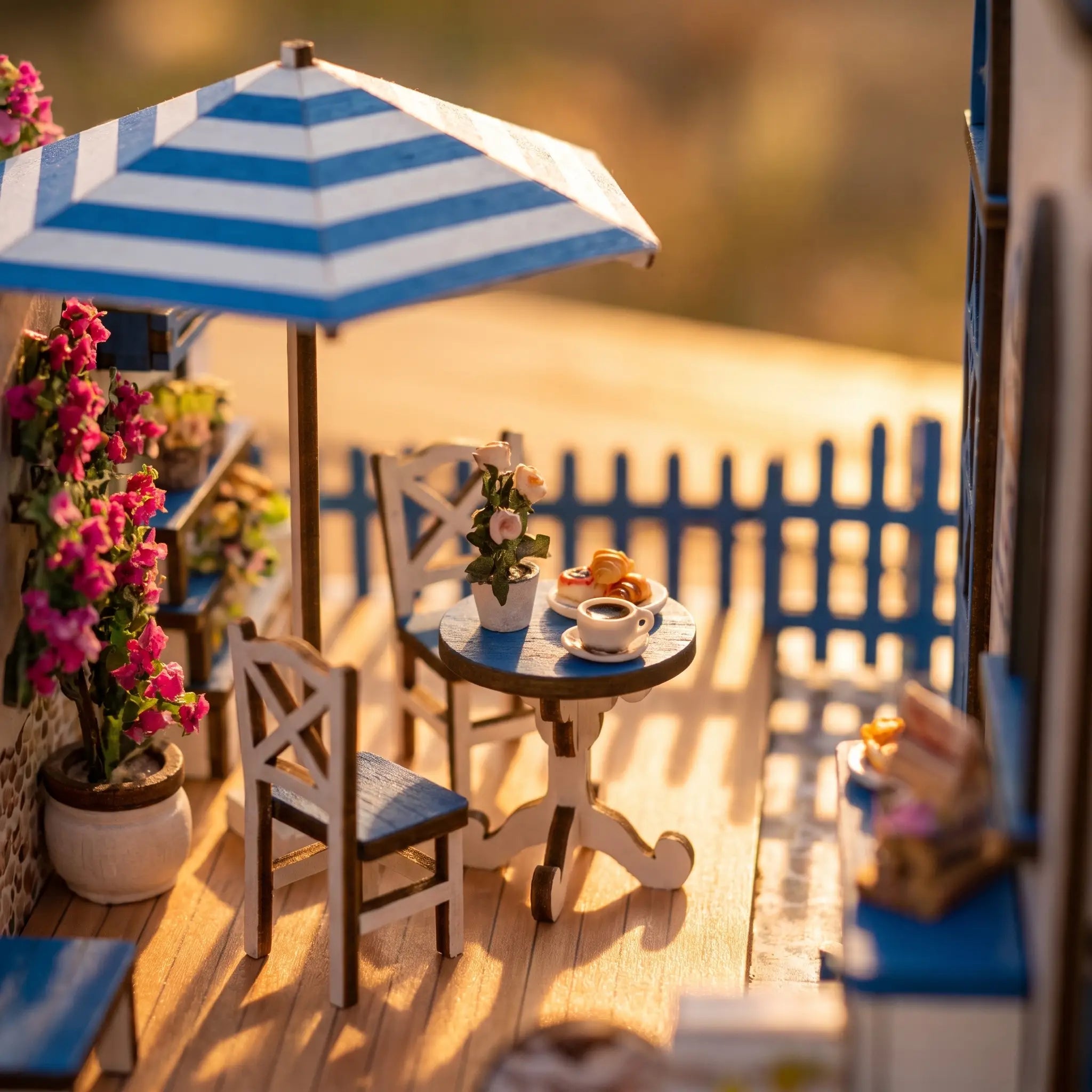 Close-up of the outdoor café table and striped umbrella of The Santorini Café miniature