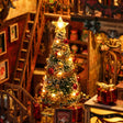 Macro detail of the lit Christmas tree inside the book nook with gifts at its base