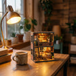 The Teddy Bear Shop kit on a cozy wood desk with a mug and books, lights glowing