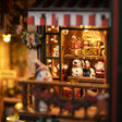 Close-up of shelves stacked with wrapped gifts, toys and ornaments under a striped awning