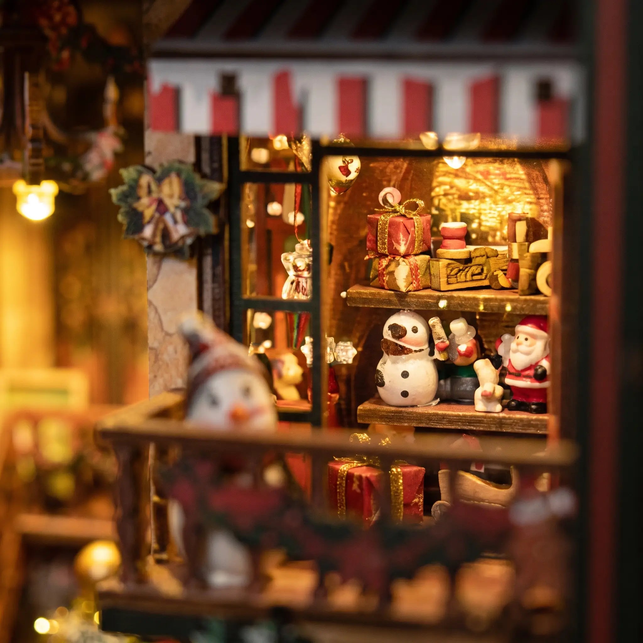 Close-up of shelves stacked with wrapped gifts, toys and ornaments under a striped awning
