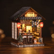 The Izakaya miniature pub on a dark walnut backdrop, warm glow