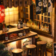 Close-up of the wooden bar counter and bottle shelves of The Izakaya