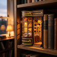 The Wand Shop book nook slotted on a home bookshelf between books at dusk