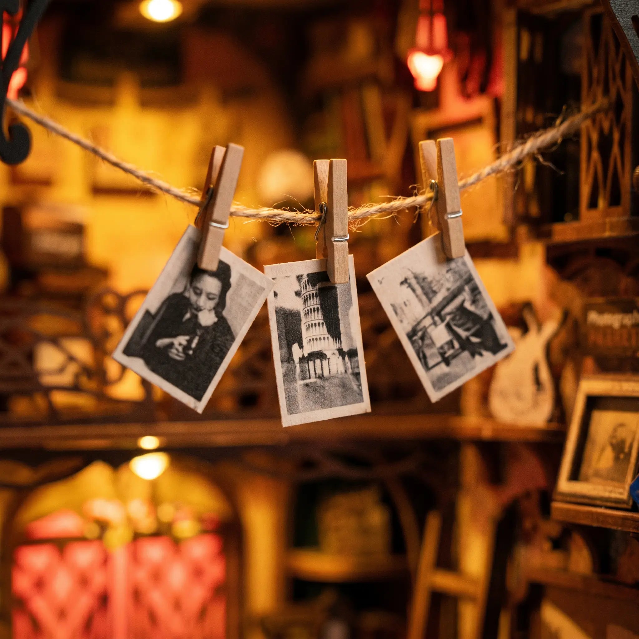 Close-up of tiny prints hanging to dry inside The Darkroom book nook