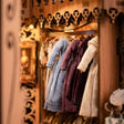 Detail of the dress racks, tiny gowns and coats in the dressing room