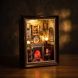 The Fireside Parlour book nook on a dark walnut surface, glowing Victorian parlour interior
