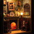 Close-up of the lit fireplace, mantel clock and reading lamp inside The Fireside Parlour