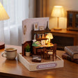 The Writer's Room miniature styled on a wooden desk with a mug and books