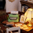 Detail of the green typewriter, quill and inkwell on the desk