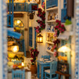 Close-up of the lit taverna inside The Aegean Alley miniature book nook