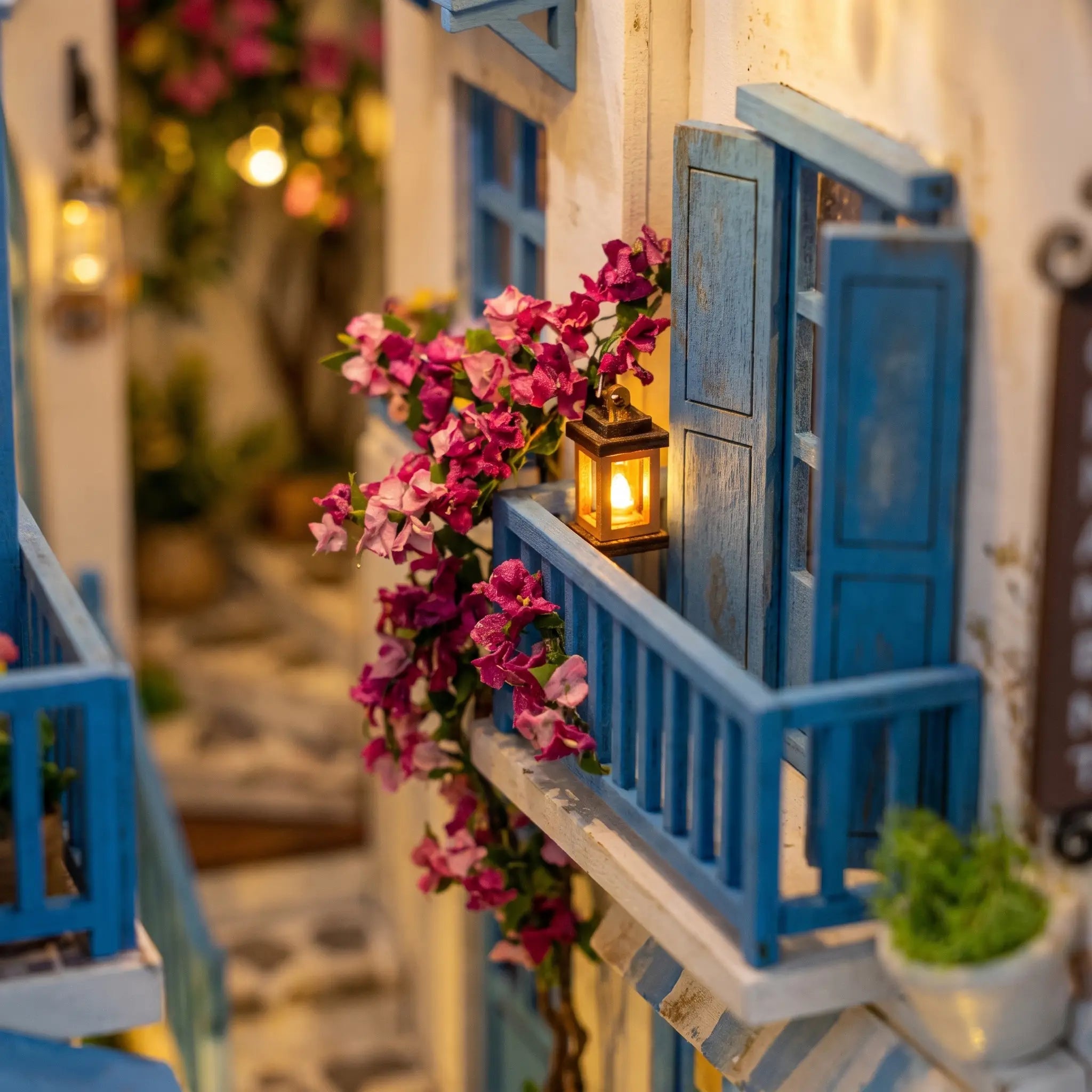 Close-up of a bougainvillea-draped blue balcony in The Aegean Alley miniature book nook