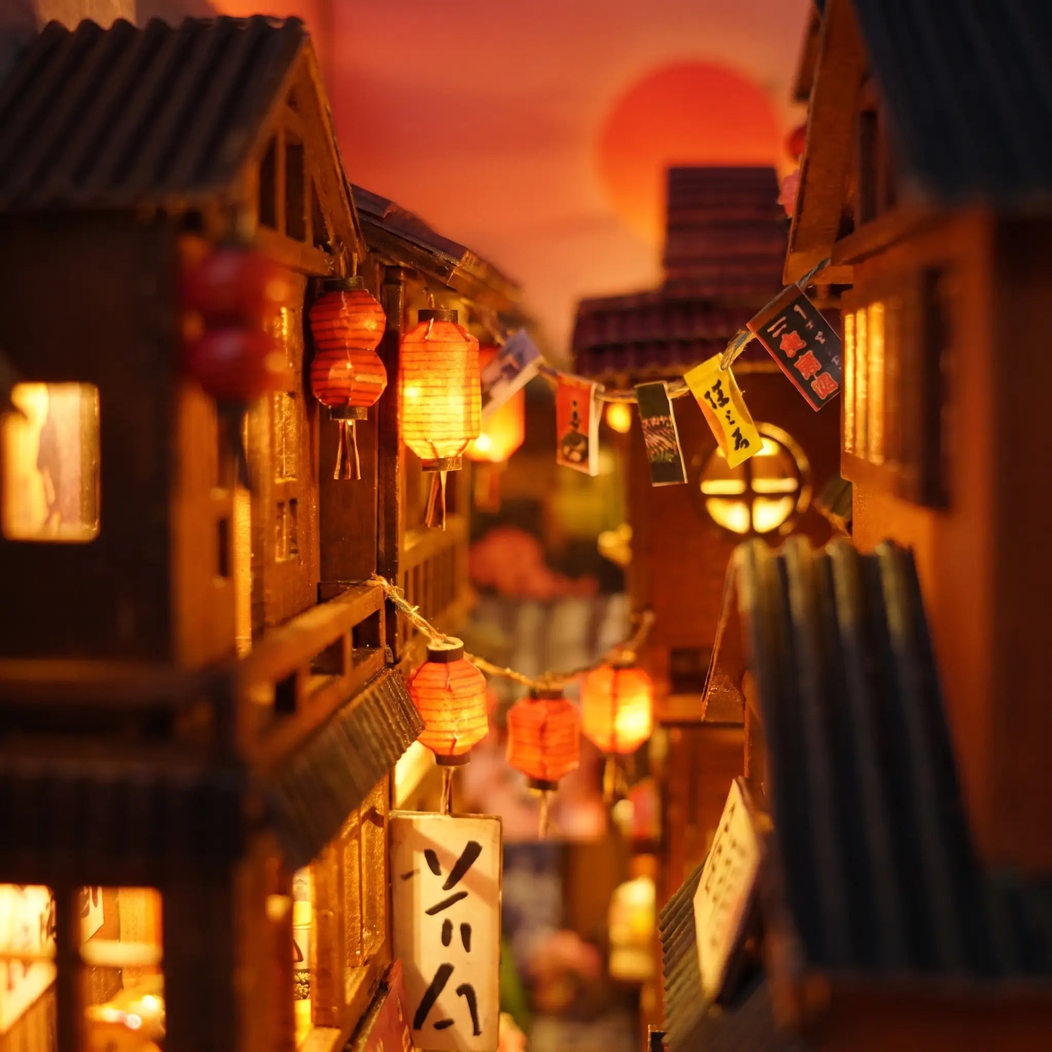 Close-up of red paper lanterns strung overhead in The Lantern Alley book nook