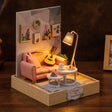 The Sunday Lounge miniature living room music corner on dark walnut, floor lamp glowing