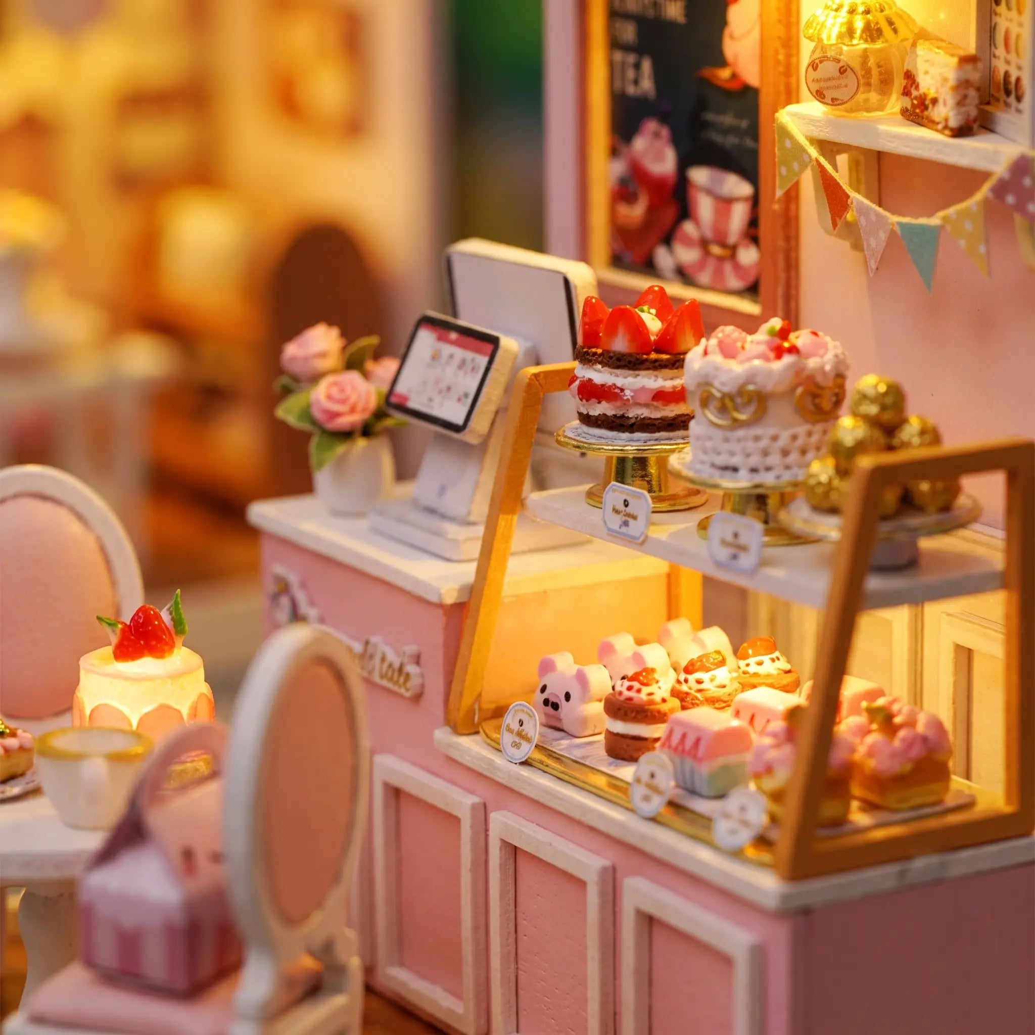 Close-up of the lit cake display counter inside The Cake Shop
