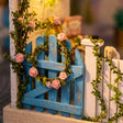 Close-up of the blue picket gate with climbing roses