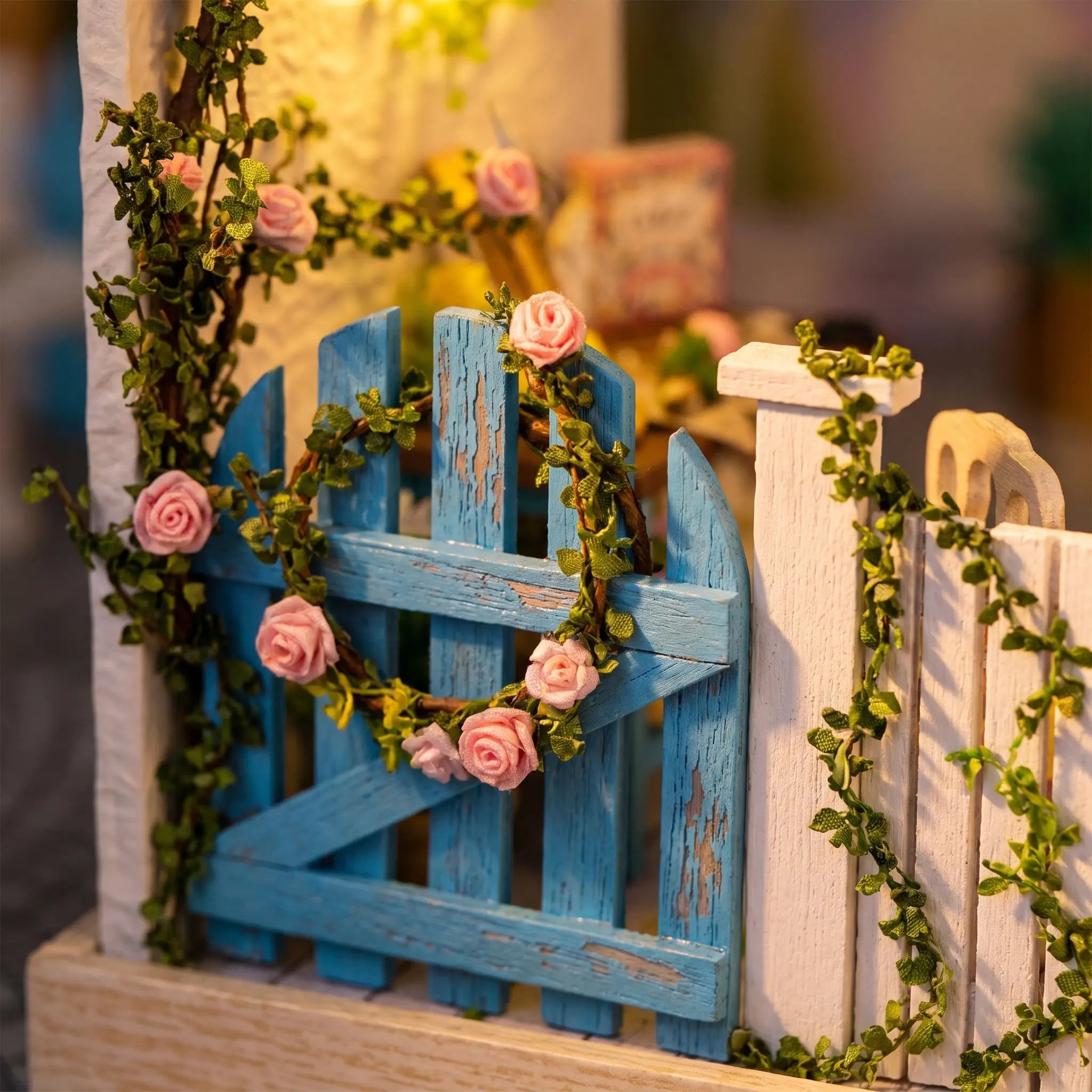 Close-up of the blue picket gate with climbing roses