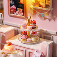 Close-up of a tiered cake stand of strawberry cakes and macarons in The Cake Shop