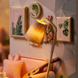 Close-up of the floor lamp and botanical wall prints in The Sunday Lounge