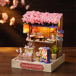 The Ramen Stall lit on a dark walnut backdrop, warm lantern glow