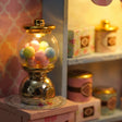 Close-up of the lit gumball machine and candy jars