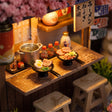 Close-up of the wooden noodle counter with ramen bowls and a steaming pot