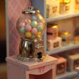 Close-up of the chrome gumball machine filled with pastel gumballs
