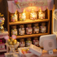 Close-up of the glass candy jars filled with pastel sweets on the shelves