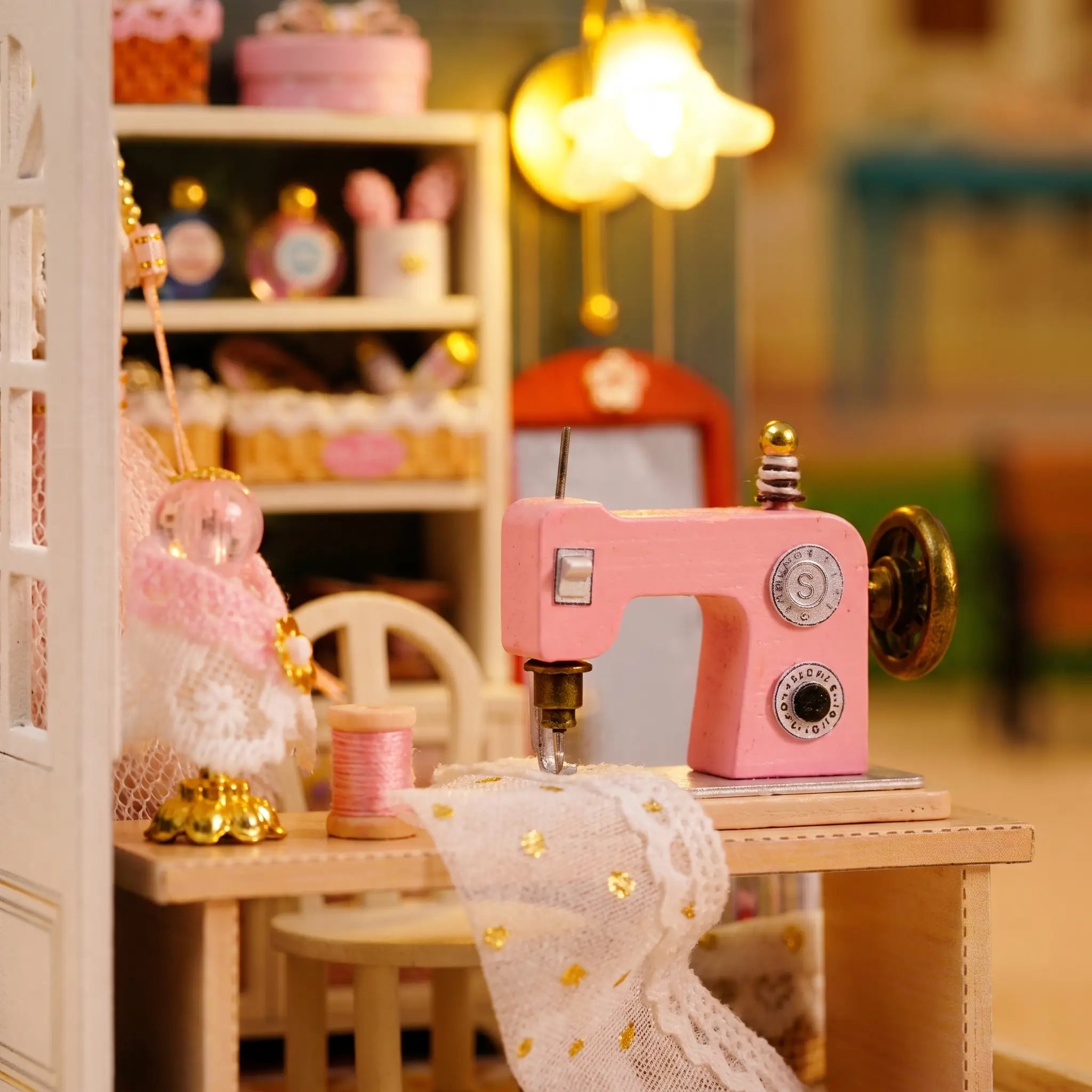 Close-up of the pink sewing machine and lace fabric in The Sewing Corner