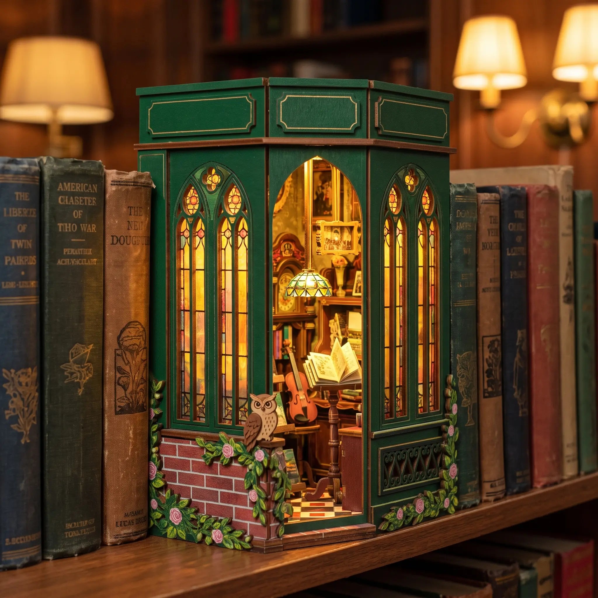 The Owl Bookshop slotted on a bookshelf between books, glowing warmly at dusk