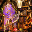 Close-up of the glowing zodiac window and telescope inside The Zodiac Chamber