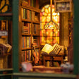 Macro close-up of the warm lit interior of The Owl Bookshop with Tiffany lamp and tiny books