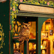 Close-up of the carved owl perched on the corner of The Owl Bookshop