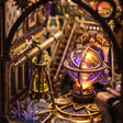 Close-up of the brass telescope and glowing orrery inside The Zodiac Chamber