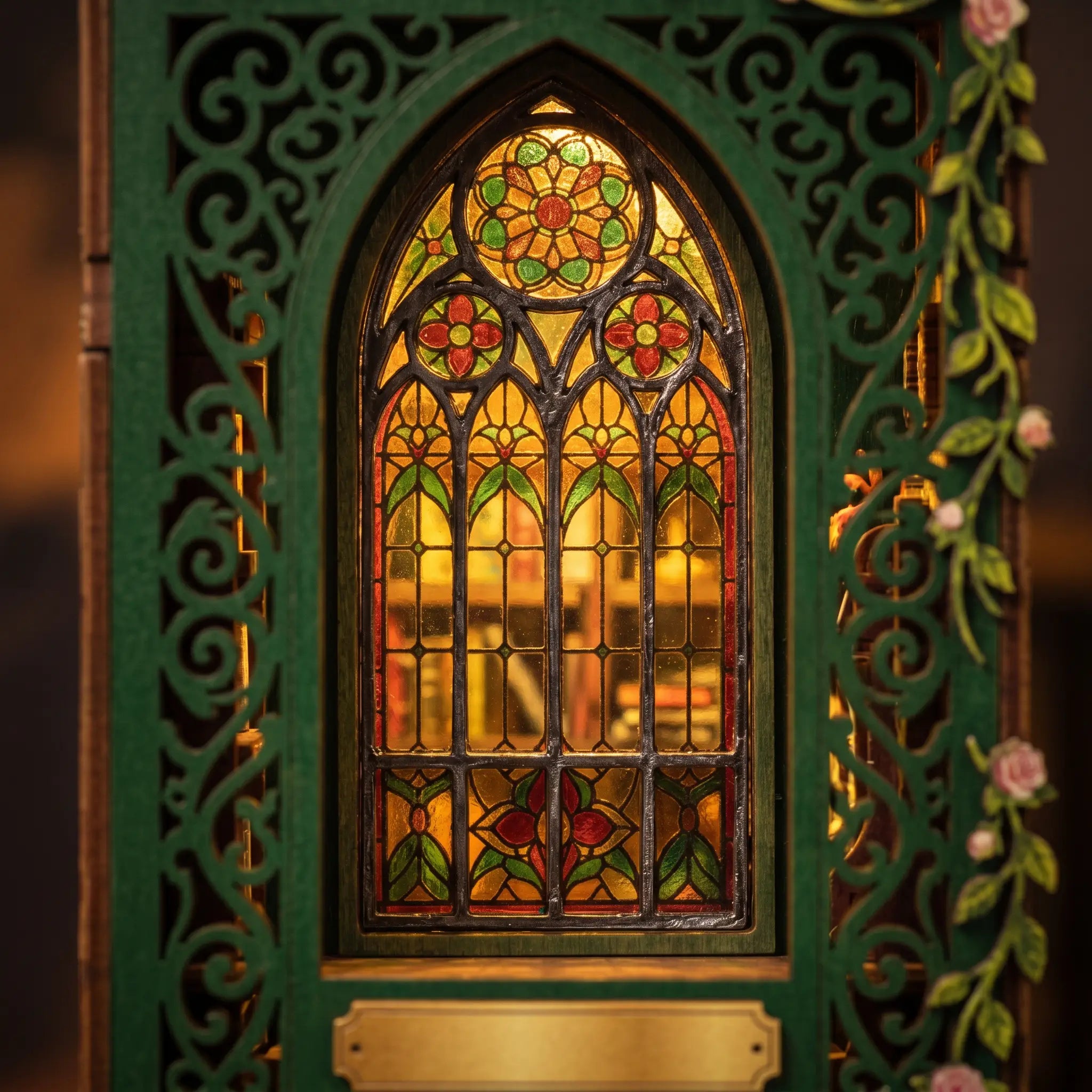 Close-up of the glowing arched stained-glass window of The Owl Bookshop