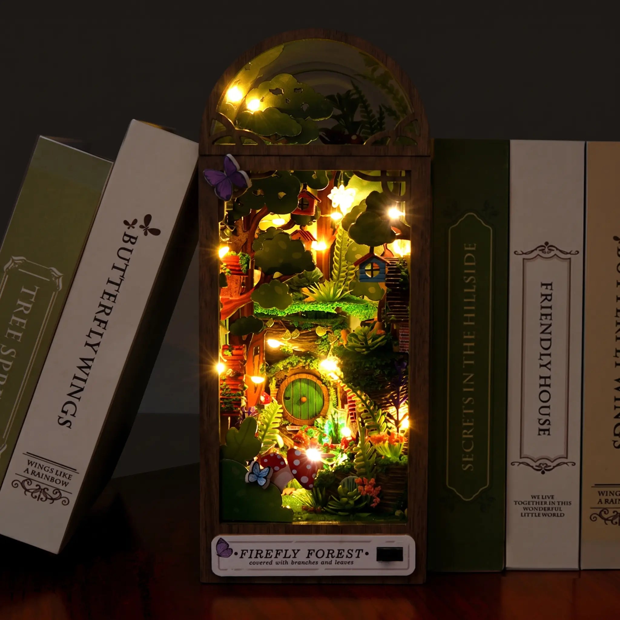 The Firefly Forest DIY book nook lit on dark walnut