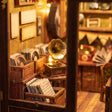 Macro detail of the lit interior of The Record Shop with a gramophone and crates of vinyl records