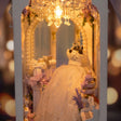 Close-up of the bride in a white lace gown among pastel hydrangeas in the chapel