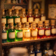 Close-up of glowing potion bottles on a shelf inside The Enchantment Shop