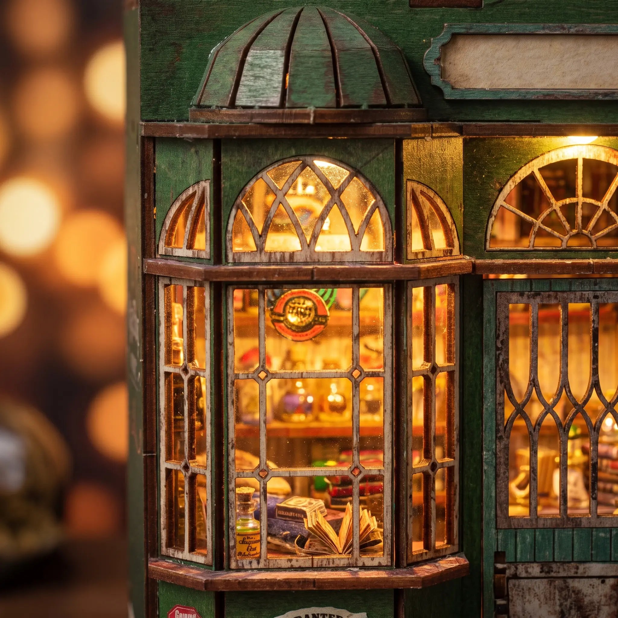 Close-up of the glowing green Victorian shopfront window of The Enchantment Shop