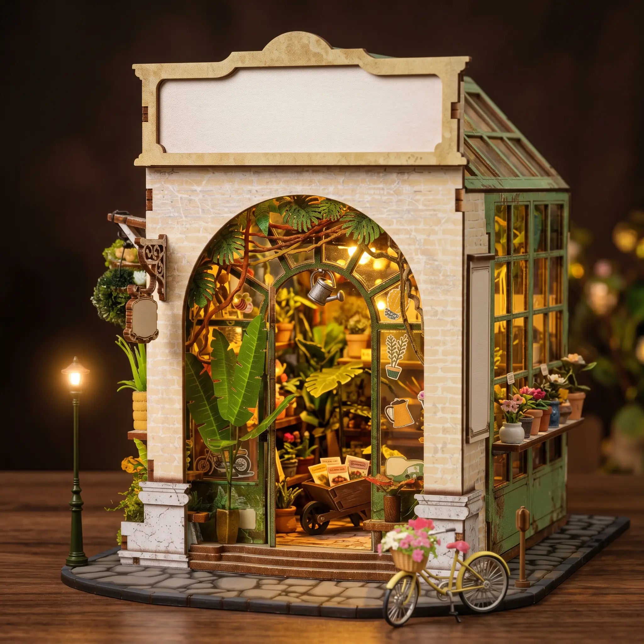 The Spring Conservatory DIY book nook kit, cream-stone greenhouse with a glass conservatory roof and glowing plants