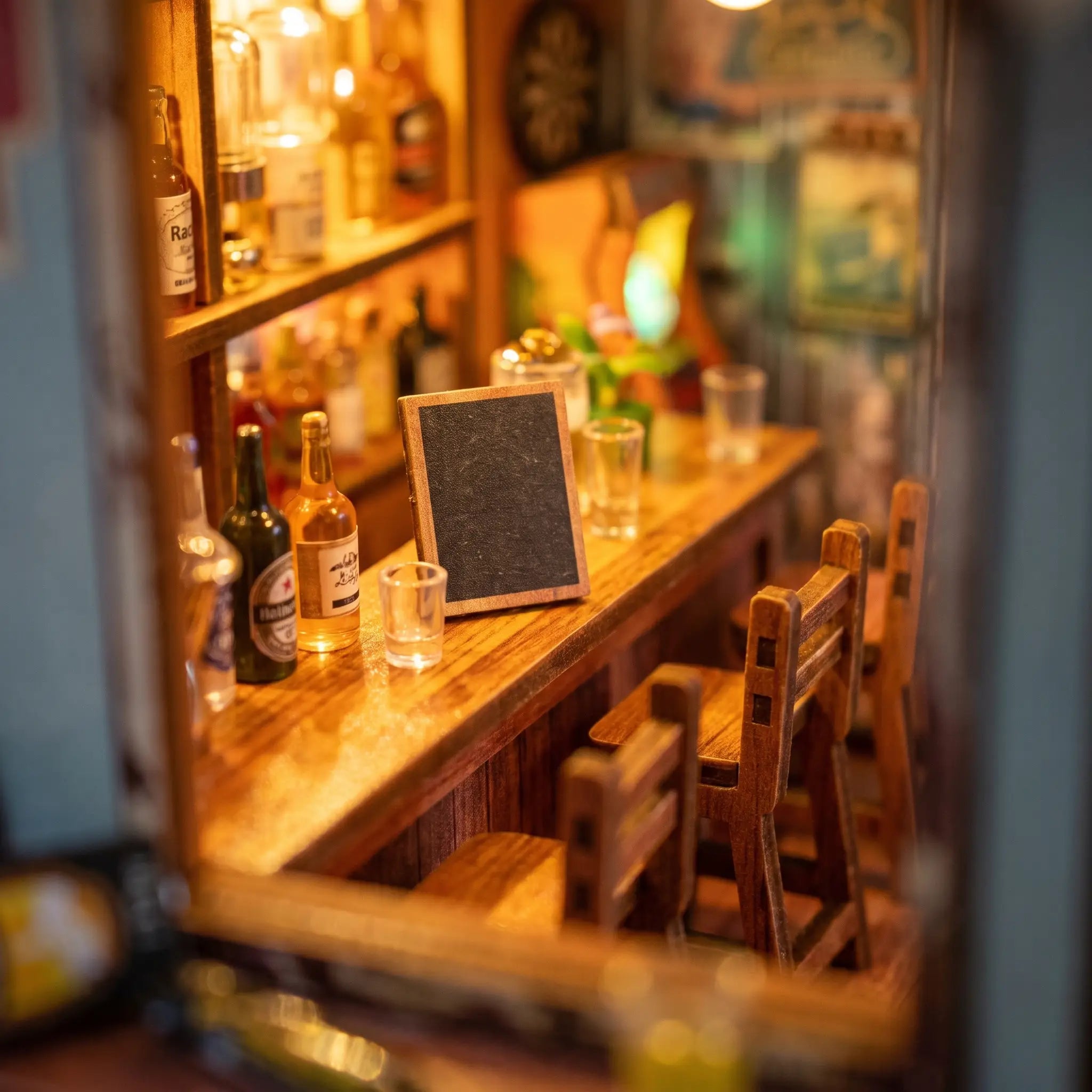 Macro detail of the wooden bar counter with tiny stools and a blank chalkboard