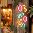 Macro detail of the glowing abstract neon signs on weathered wood