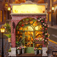 Macro of The Blossom House lit interior, flower buckets and arched green door